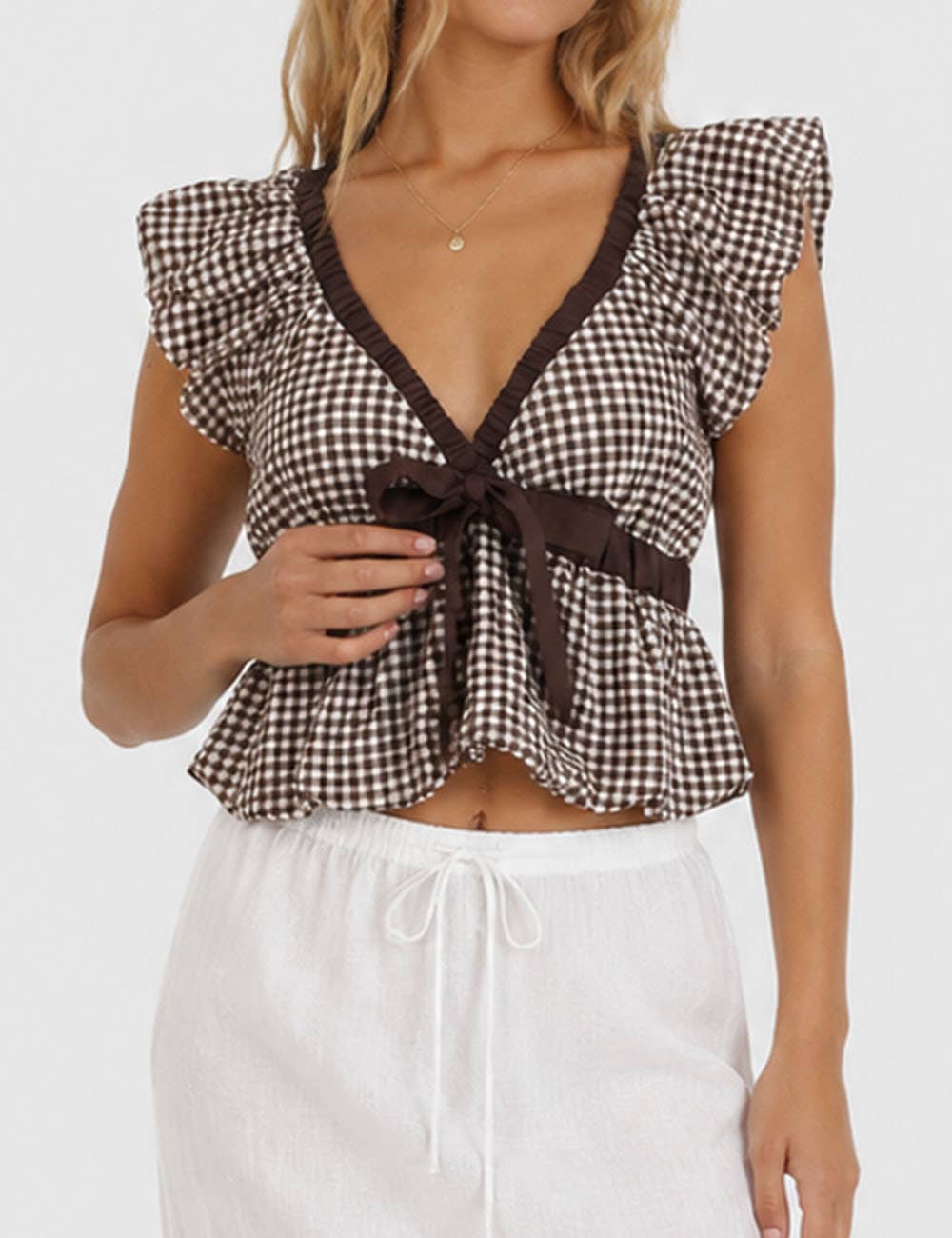 The Sutton Plaid Ruffle Sleeveless Bow Tie Peplum Top